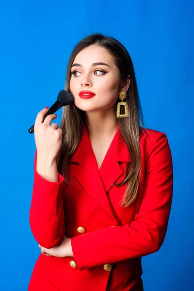 Attractive woman applying makeup brush. Hiding all imperfections. Perfect skin tone. Makeup artist concept. Girl apply powder cheeks. Looking good and feeling confident. Gorgeous lady makeup red lips