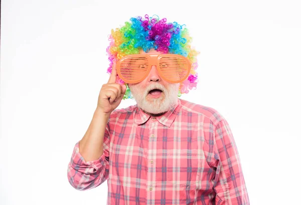 Nice joke. Elderly clown. Man senior bearded cheerful person wear colorful wig and sunglasses. Grandpa always fun. Having fun. Funny lifestyle. Fun and entertainment. Comic grandfather concept — Stock Photo, Image