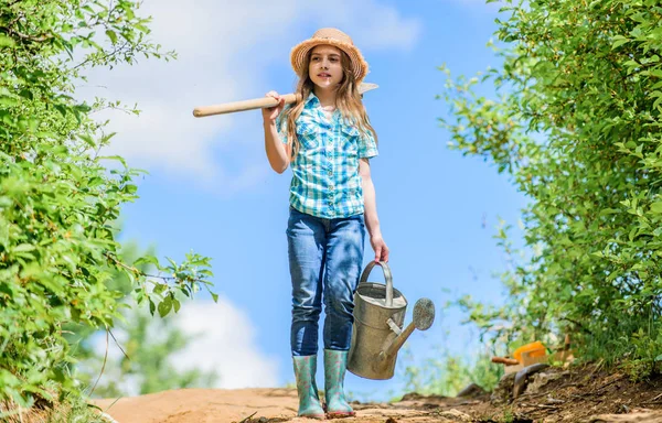 Watering tools that will solve dry yard problems. Removable rose allows moderate flow. Gardening tips. Spring gardening. Girl child hold shovel watering can. Spring gardening checklist. Little helper — Stock Photo, Image