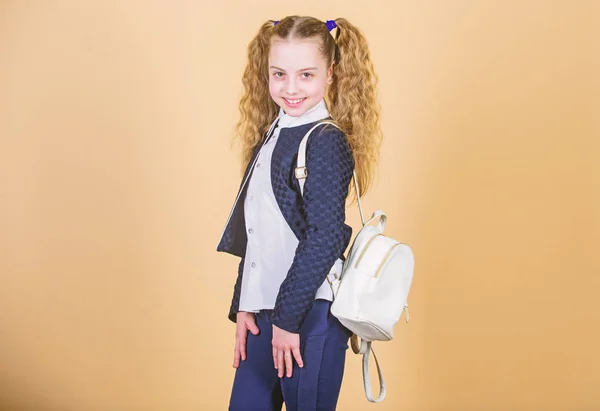 Stylish mini backpack. Learn how fit backpack correctly. Girl little fashionable cutie carry backpack. Popular useful fashion accessory. Schoolgirl with small leather backpack. Carry bag comfortable