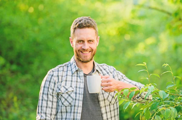 drink tea outdoor. ecological life for man. man in green forest. morning coffee. healthy lifestyle. nature and health. breakfast refreshment time. happy man with cup of tea. Enjoying morning coffee