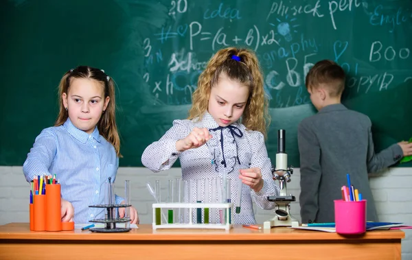 Explore biological molecules. Future technology and science concept. Children study biology or chemistry school. School education. School girls study. Kids in classroom with microscope and test tubes