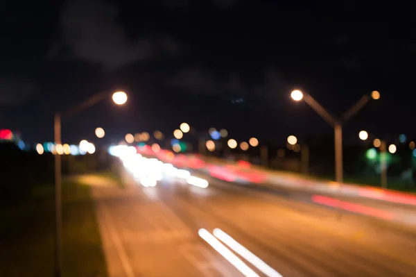 Watching transport moving in street. Urban traffic. Blurred car lights night. Urban night. Lights defocused background. Night city lights. Illumination and lighting. White and red blurred lamps — Stock Photo, Image