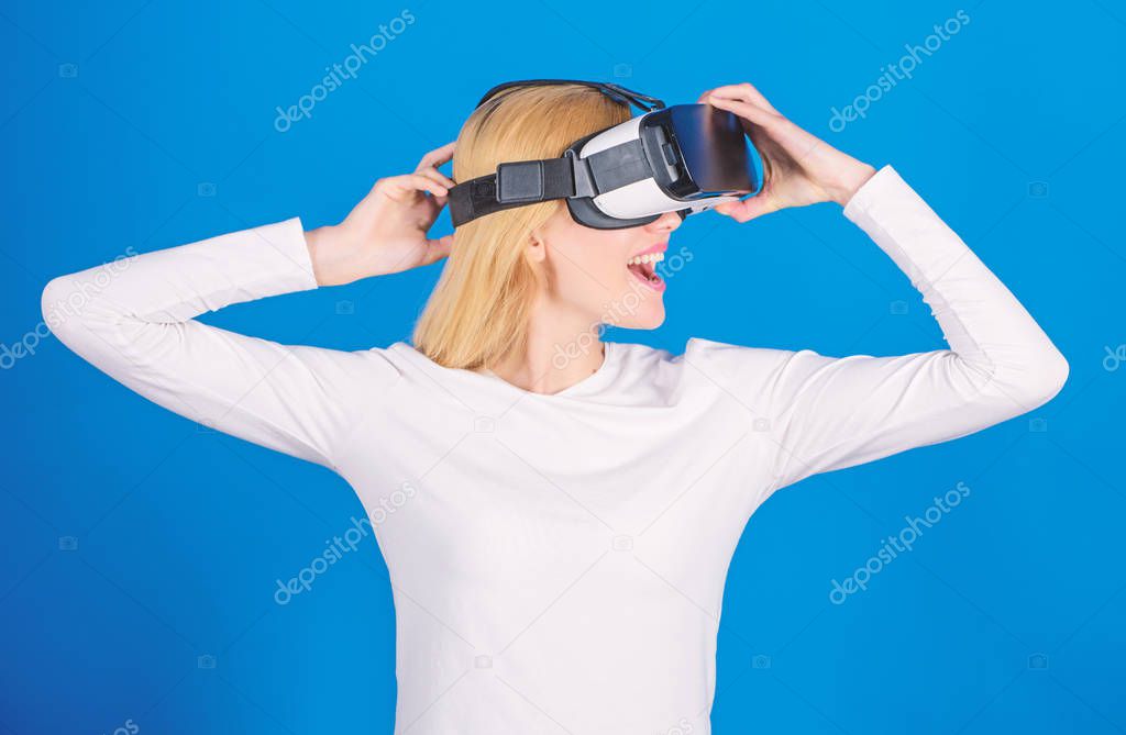 Woman using virtual reality headset. Portrait of young woman wearing VR goggles, experiencing virtual reality using 3d headset. The woman with glasses of virtual reality. Digital VR.