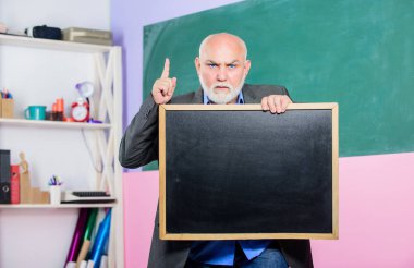 bear in mind. exam and graduation results. information is here. senior man teacher with empty blackboard. place for copy space. Mature teacher man hold chalk board. back to school. Education concept clipart