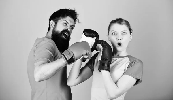 Man and woman in boxing gloves. Boxing sport concept. Couple girl and hipster practicing boxing. Sport for everyone. Amateur boxing club. Equal possibilities. Strength and power. Family violence