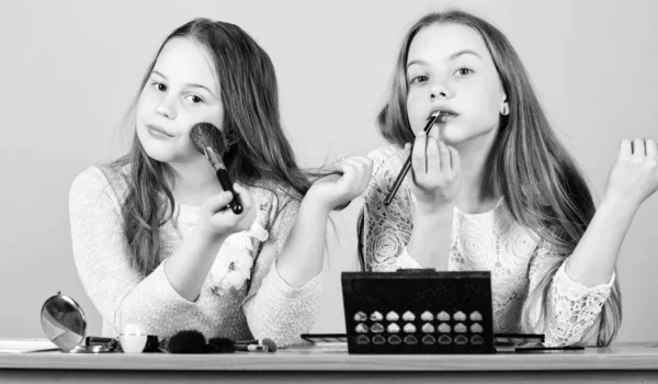 Makeup store. Experimenting with style. Makeup art. Explore cosmetics bag concept. Salon and beauty treatment. Just like playing with makeup. Makeup courses. Children little girls choose cosmetics