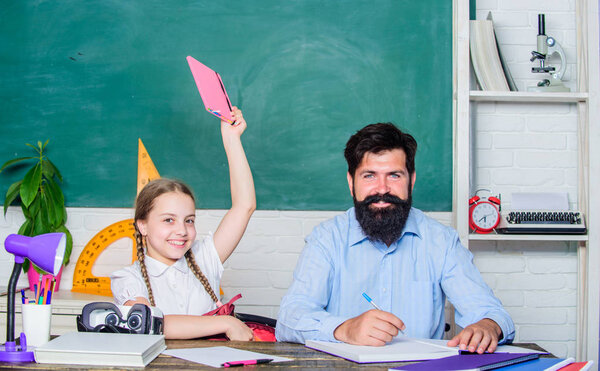 Preparing to exams. back to school. Private teaching. small girl child with bearded teacher man in classroom. daughter study with father. Teachers day. knowledge day. Home schooling. private lesson