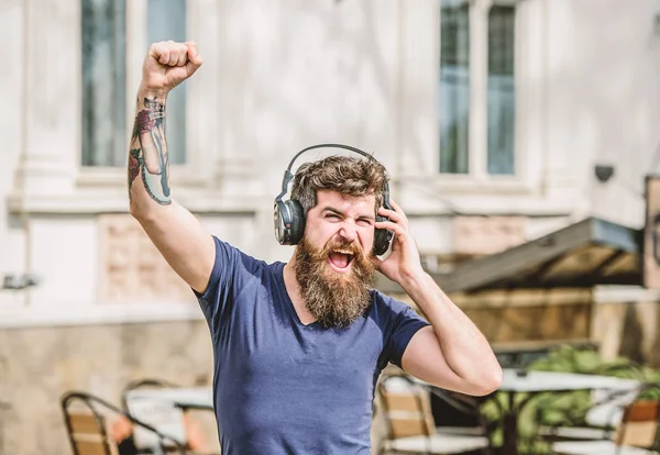 Man listen to music in headphones. brutal caucasian hipster with moustache. Music is my religion. Enjoying music. Mature hipster with beard. Sharing favorite music. Bearded man