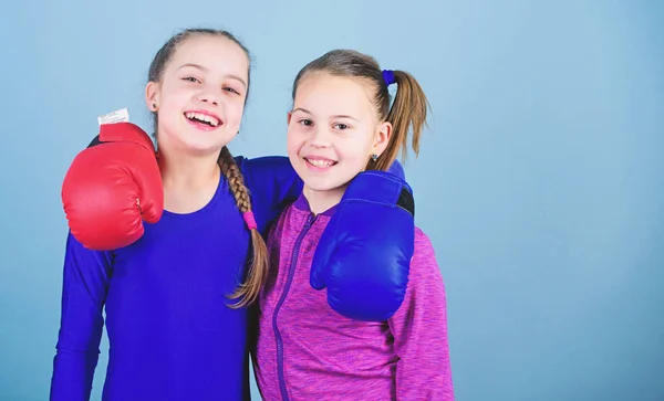 Girls in boxing sport. Boxer children in boxing gloves. Confident teens. Female boxers. Boxing provide strict discipline. Girls cute boxers on blue background. Competitors on ring and friends in life