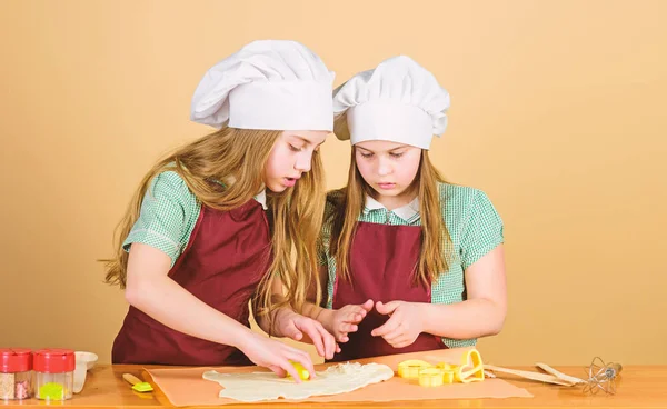 鍋を焼く神々じゃない小さな子供たちはパイを焼くためにペーストを転がします。パン屋で生地を準備愛らしい小さな女の子。パンを焼くことを学ぶかわいい子供たち — ストック写真