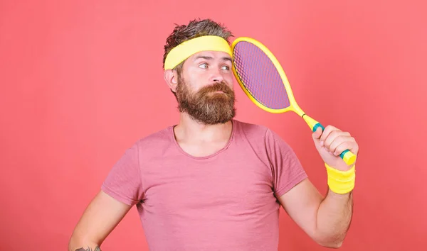 Reach top again. Tennis player retro fashion. Tennis sport and entertainment. Athlete hipster hold tennis racket in hand red background. Play tennis for fun. Man bearded hipster wear sport outfit — Stock Photo, Image