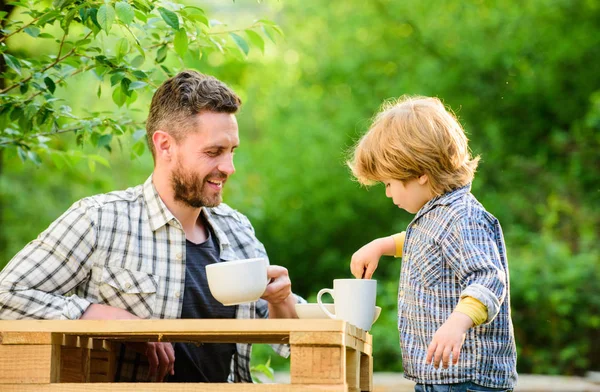 Feed in right way for childs stage of development. Feed son solids. Feed your baby. Natural nutrition concept. Dad and cute toddler boy having lunch outdoors. Child care. Feeding son natural foods — Stock Photo, Image