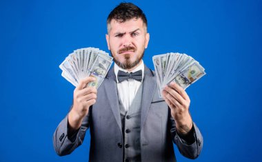 Gerçek para kazan. Zenginlik ve refah kavramı. Nakit işlem işi. Kolay nakit kredi. Adam resmi takım birçok dolar banknotlar mavi arka plan tutun. İş adamının nakit parası var. Paramı al.