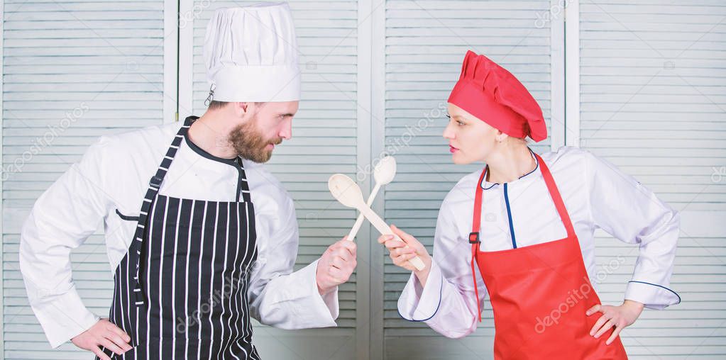 Ultimate cooking challenge. Culinary battle of two chefs. Couple compete in culinary arts. Kitchen rules. Culinary battle concept. Woman and bearded man culinary show competitors. Who cook better