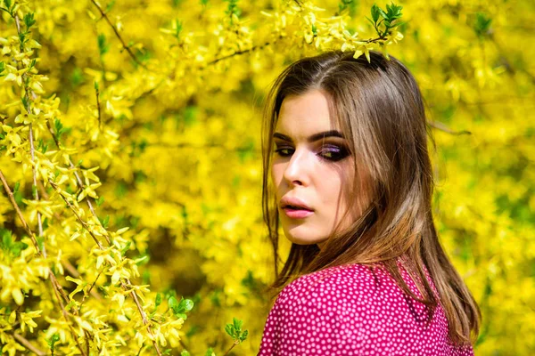 stock image pretty woman skincare. girl like nature. summer blooming trees and yellow flowers. fashion beauty. natural beauty makeup. hair fashion. sexy woman in spring blossom. spring girl with flowers