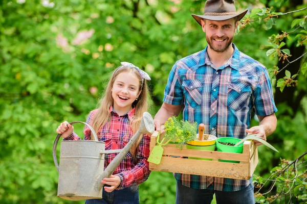 family farm. spring village country. ecology. Watering can and shovel. little girl and happy man dad. earth day. father and daughter on ranch. Beautiful florist at work. hello summer
