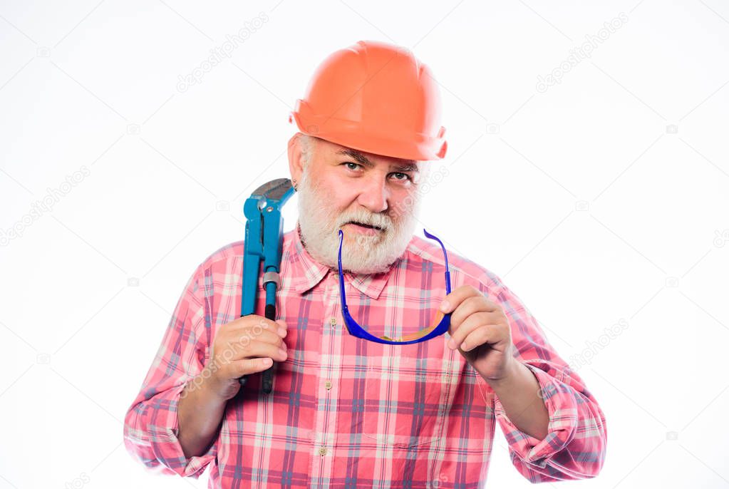 Experienced engineer. Home improvement. Plumber service. Man bearded plumber wear helmet and hold wrench tool. Repair concept. Sanitary engineering. Plumber workshop. Plumber repairing or renovating