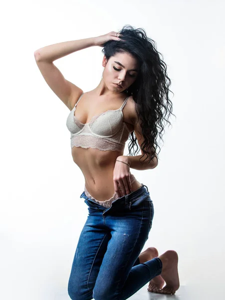Feeling free and confident. woman with perfect body relax. erotic games. Isolated on white. fashion beauty. Diet and fitness.. sexy woman in jeans and bra. sensual girl with curly hair. Flexible body — Stock Photo, Image