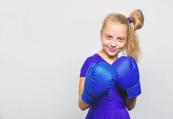 little girl in boxing gloves punching. knockout and energy. Sport success. training with coach. Fight. Boxer child workout, healthy fitness. Sport and sportswear fashion, copy space. Ready to fight