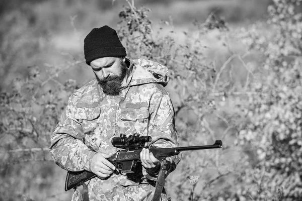 Bearded man hunter. Military uniform fashion. Army forces. Camouflage. Hunting skills and weapon equipment. How turn hunting into hobby. Man hunter with rifle gun. Boot camp. he is a business shark