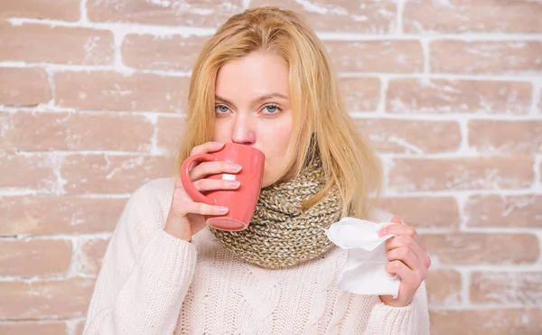 Runny nose and other symptoms of cold. Cold and flu remedies. Drink more liquid get rid of cold. Drinking plenty fluid important for ensuring speedy recovery from cold. Girl hold tea mug and tissue