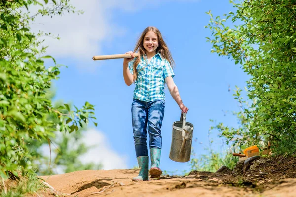 Gardening guide for beginners. Gardening tips. Spring gardening. Girl child hold shovel watering can. Spring gardening checklist. Little helper. Watering tools that will solve dry yard problems — Stock Photo, Image