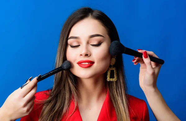 Pretty woman applying makeup brush. Perfect skin tone. Stunning beauty. Makeup supplies shop. Makeup courses. Gorgeous lady make up red lips. Skin care. Cosmetics concept. Beauty salon facial care
