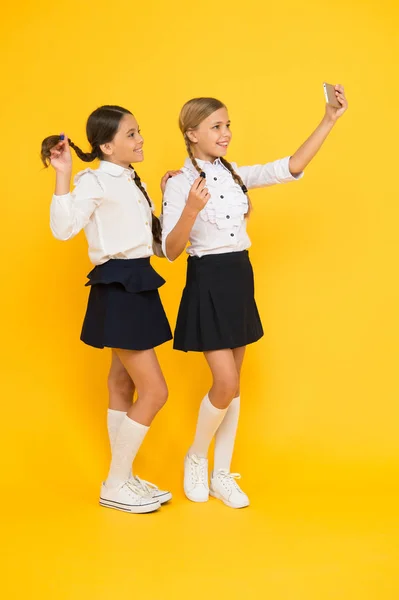 Προσωπικό μπλογκ. Κορίτσια σχολική στολή πάρει selfie smartphone. Πάρτε τέλεια φωτογραφία. Τα κορίτσια θέλουν μόνο να διασκεδάσουν. Μαθήτριες χρησιμοποιούν κινητό τηλέφωνο smartphone λήψη φωτογραφίας. Selfie φωτογραφία για τα κοινωνικά δίκτυα — Φωτογραφία Αρχείου