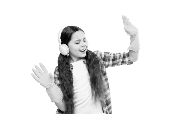 Playing music can cut cleaning time in half. Girl wear headphones and protective gloves for cleaning. Listening music and cleaning house. Having fun. Make household more joyful. Cleaning and dancing — Stock Photo, Image