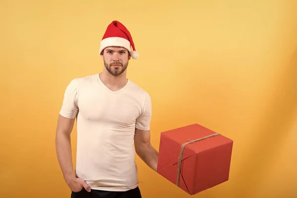サンタの帽子の男は、クリスマス プレゼントを保持します。クリスマス前に朝。黄色の背景に幸せなサンタの男。配信クリスマス プレゼント。クリスマスのオンライン ショッピング。新年あけましておめでとうございます、コピー スペース。クリスマスの楽しみ — ストック写真