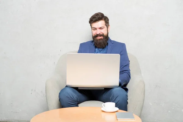 Communication makes a business. Businessman having business communication by laptop. Hipster working on computer with wireless communication in office. Using online communication tools — Stock Photo, Image