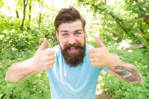 Summer fun. Bearded guy in park forest. Bearded hipster. Crazy bearded man in natural environment. Hipster with long beard emotional face close up nature background. Go wild. Hair care male beauty