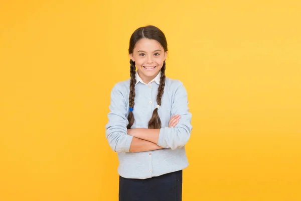 Congratulations. smart little girl on yellow background. knowledge day. childhood happiness. education concept. back to school. happy girl in school uniform. kid fashion. school market — Stock Photo, Image