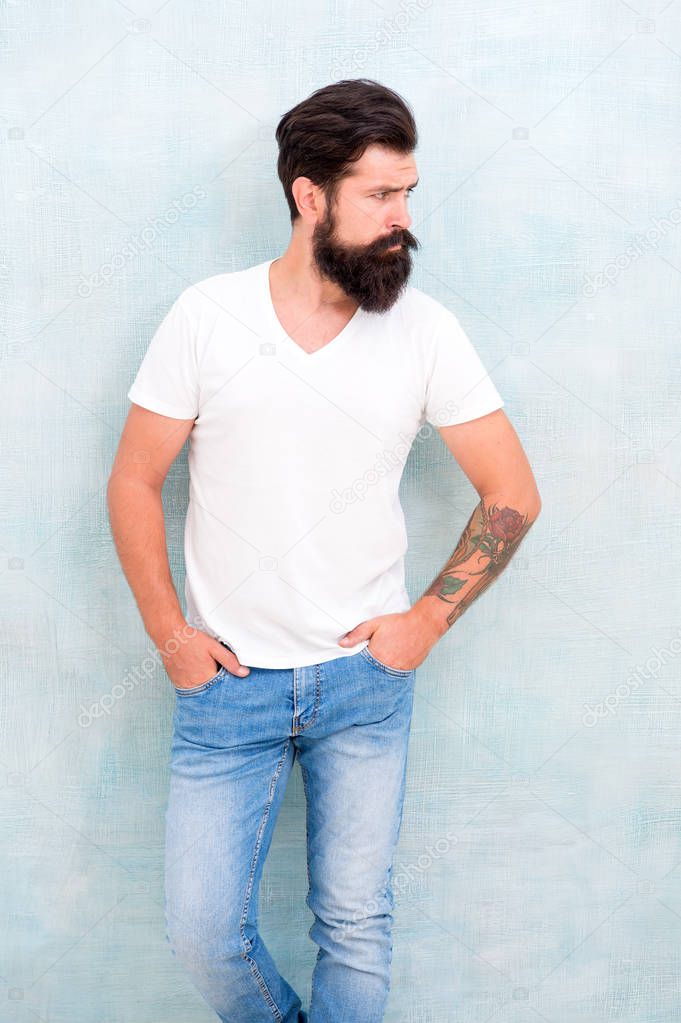 Simple and casual. Masculinity concept. Fashion and beauty. Hipster long well groomed beard and mustache. Casual style daily life. Male temper brutality. Brutal macho casual outfit gray background