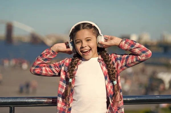 Listen for free. Get music family subscription. Access to millions of songs. Enjoy music everywhere. Best music apps that deserve a listen. Girl child listen music outdoors with modern headphones
