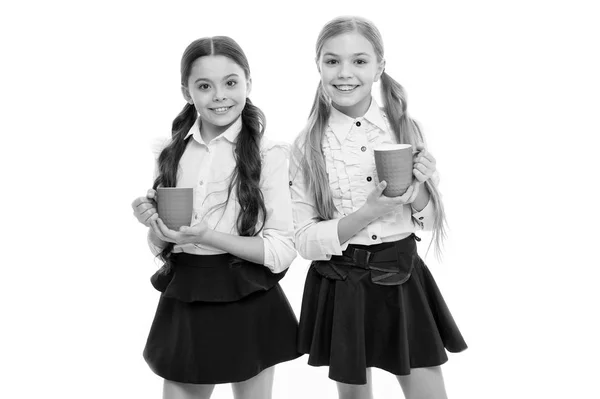 Time to relax. Schoolgirls with mugs having tea break. Relax and recharge. Water balance concept. Enjoying tea together. Friends drink water. More energy. Girls children long hair drink cocoa or tea — Stock Photo, Image