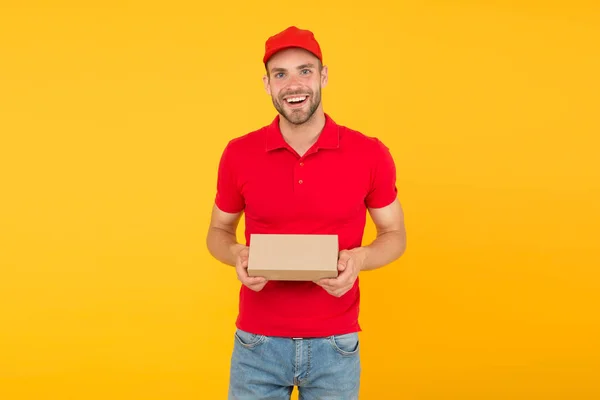 Courier service delivery. Salesman and courier career. Courier and delivery service. Postman delivery worker. Happy man post package yellow background. Delivering your purchase. Gifts for holidays