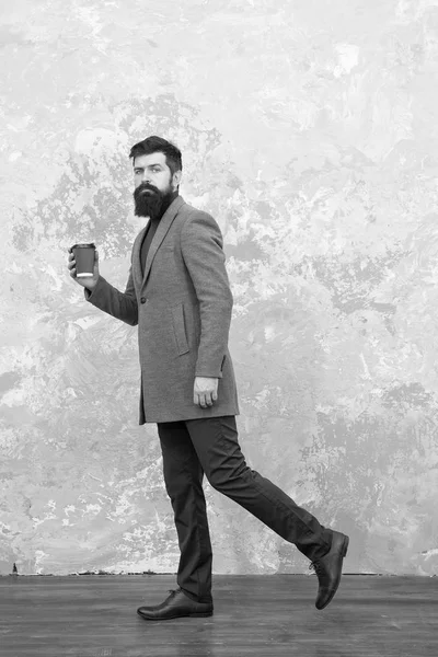 trendy man with beard. Brutal bearded hipster in denim wear. Casual style. Modern life. Male fashion model. Mature businessman drink coffee on go. Hurrying to be in time. Hurrying to office