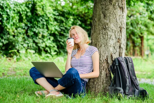 modern woman with computer outdoor. Pretty woman drinking takeaway coffee. summer online. Morning chart. girl work on laptop. girl drink coffee to go. Relax in park. Using modern technologies