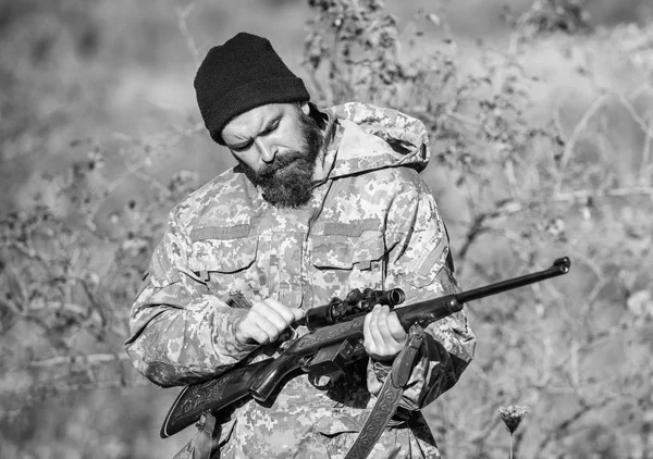 Man hunter with rifle gun. Boot camp. Military uniform fashion. Bearded man hunter. Army forces. Camouflage. Hunting skills and weapon equipment. How turn hunting into hobby. Please no.