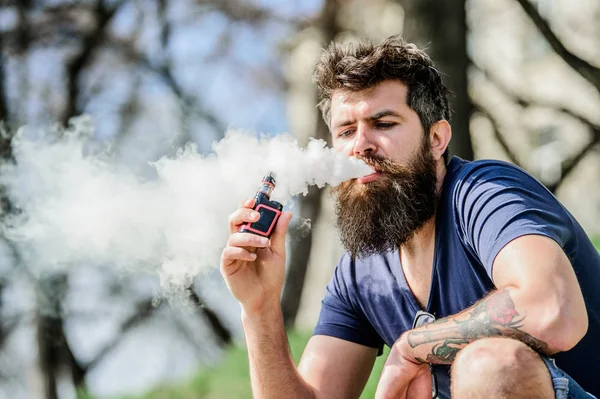 Health safety and addiction. inhaling vapor. man smoking e-cigarette. Bearded brutal male smoking electronic cigarette. Mature hipster with beard. hipster man hold vaping device. Freedom in his veins