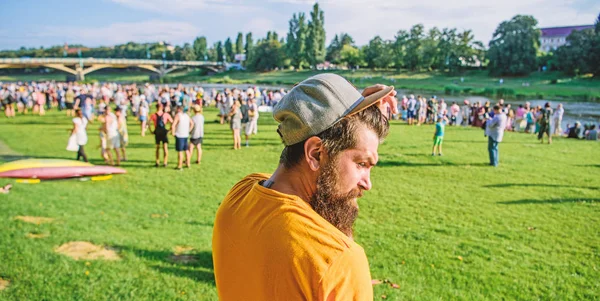 Guy celebrate holiday or festival. Summer fest. Man bearded hipster in front of crowd. Book ticket now. Open air concert. City day. Music festival. Entertainment concept. Visit summer festival