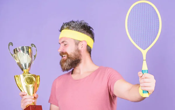 Tennis player win championship. Athlete hold tennis racket and golden goblet. Win tennis game. Man bearded hipster wear sport outfit. Success and achievement. Win every tennis match i take part in