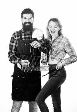 Aile hafta sonu. Aşık çift barbekü için mutfak eşyaları tutun. Açık havada et kavurma araçları. Piknik ve barbekü. Mutfak konsepti. Adam sakallı hipster ve kız barbekü partisi için hazır