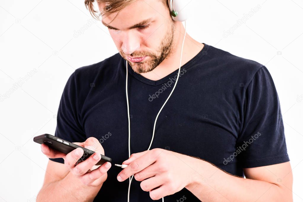 man using wireless blue tooth headset. relax playlist. sexy muscular man listen music from playlist. man relax in earphones isolated on white. unshaven man relax with favorite song