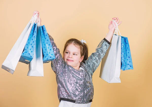 Compras e compras. Sexta-feira negra. Desconto de venda. Dia das compras. Pacotes de crianças. Moda infantil. Presente surpresa. Loja inspiradora para comprar mais. Menina com sacos de compras fundo bege — Fotografia de Stock