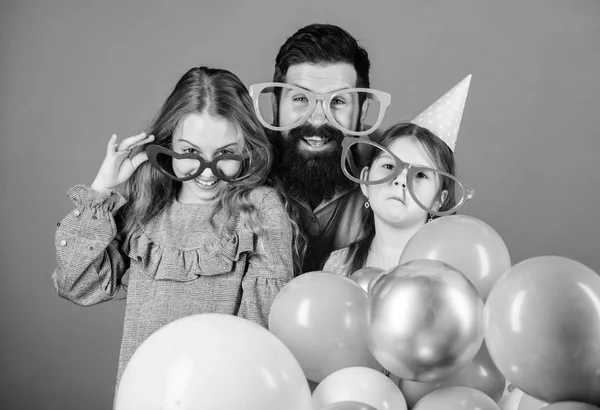 In fancy style. Father and girl children enjoying party time. Happy family celebrating birthday party. Family party. Family of father and daughters wearing party goggles. Having a family celebration