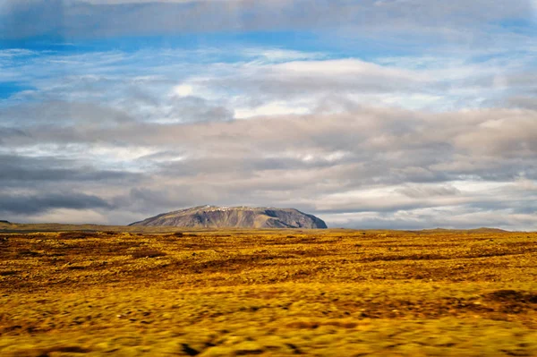 Landscape view with grass field in reykjavik, iceland. autumn landscape on cloudy sky. weather and climate. nature and ecology. high mountain in reykjavik, iceland. plain thingvellir. — Stock Photo, Image