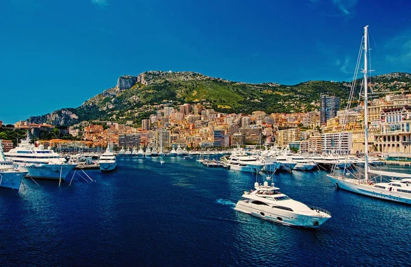 Monte Carlo, Monaco - December 08, 2009: sea harbor with yachts and city on mountain landscape. Houses on sea shore with sailing and power boats. Sea adventure and boat trips. Vacation and wanderlust — Stock Photo, Image